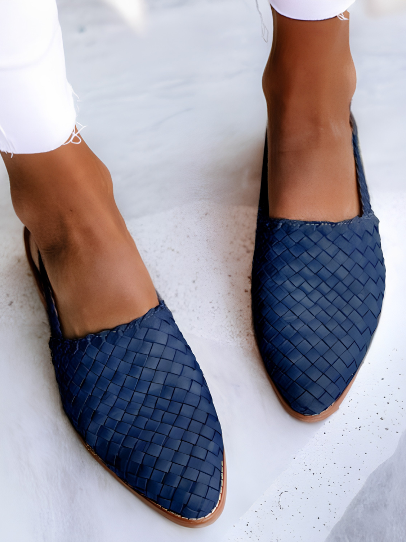 Overhead view of blue handcrafted moccasins arranged neatly, focusing on the vibrant color and slip-on design.