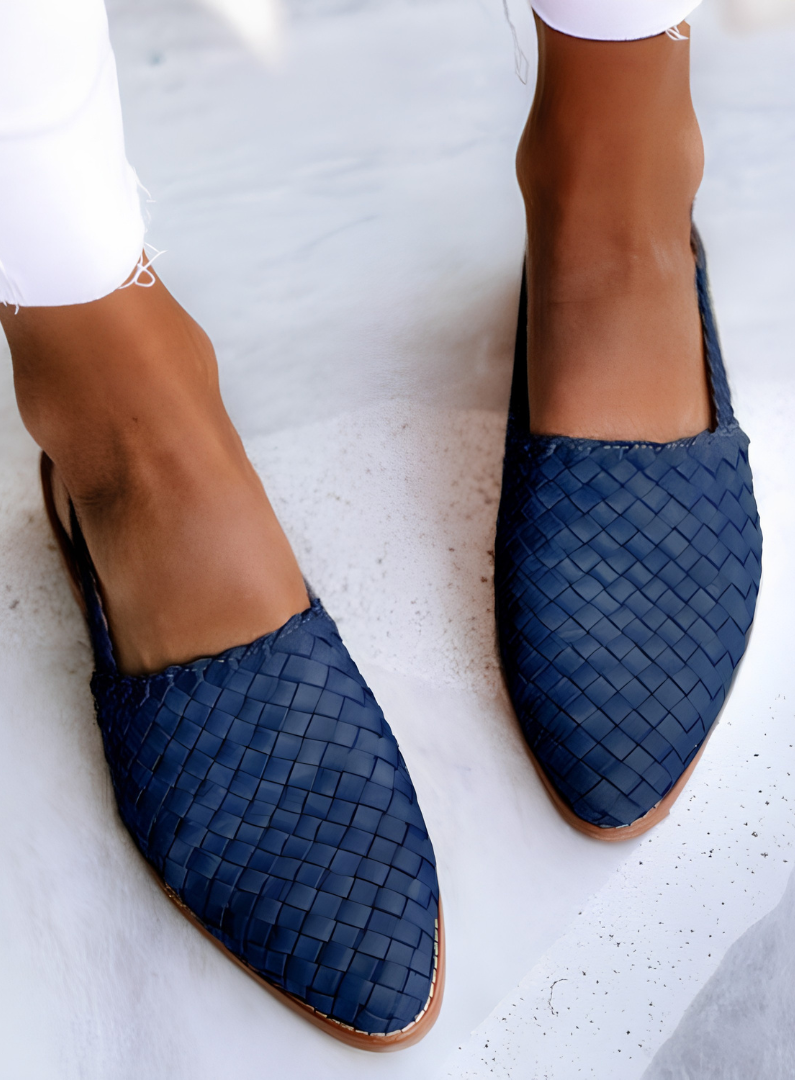 Overhead view of blue handcrafted moccasins arranged neatly, focusing on the vibrant color and slip-on design.