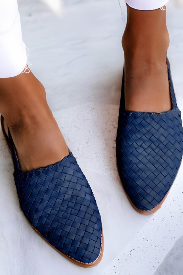 Overhead view of blue handcrafted moccasins arranged neatly, focusing on the vibrant color and slip-on design.