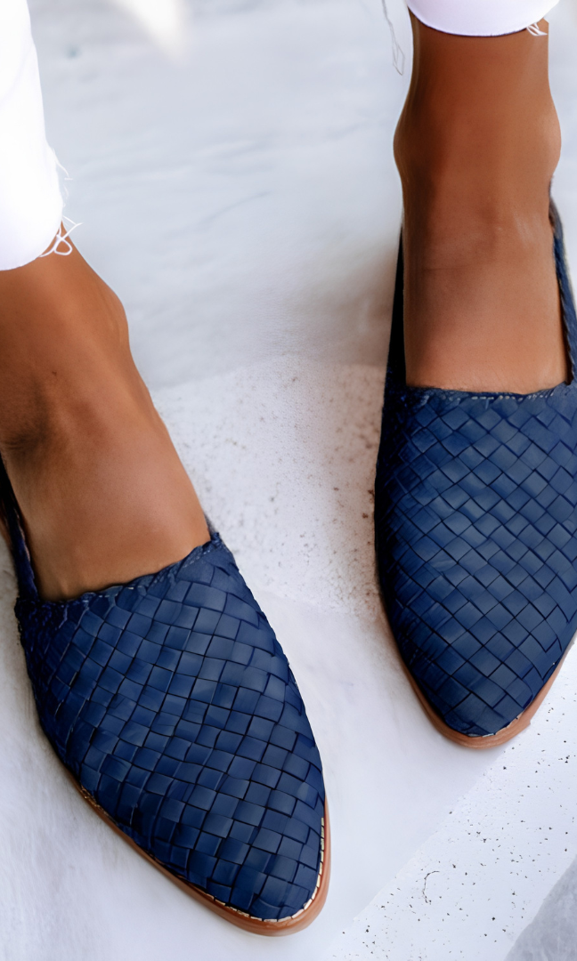 Overhead view of blue handcrafted moccasins arranged neatly, focusing on the vibrant color and slip-on design.
