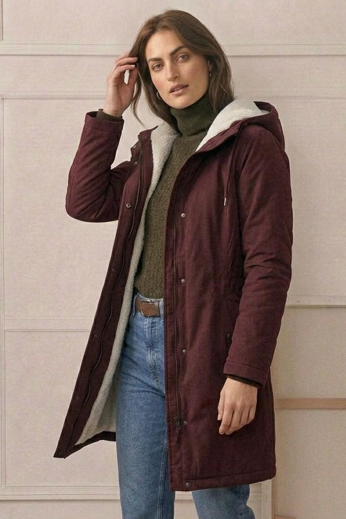 Back view of the Elara parka, showing the deep, fixed storm hood and overall elegant drape.