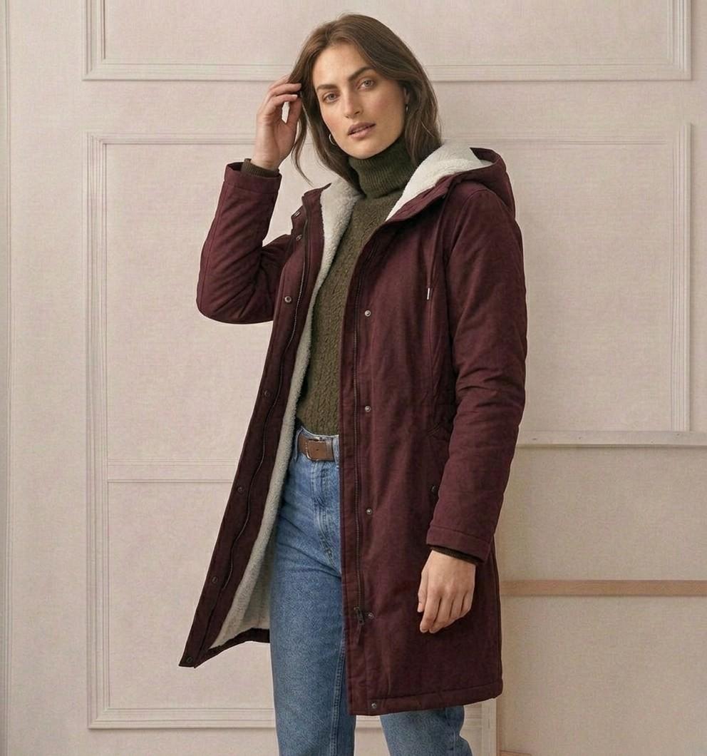 Back view of the Elara parka, showing the deep, fixed storm hood and overall elegant drape.