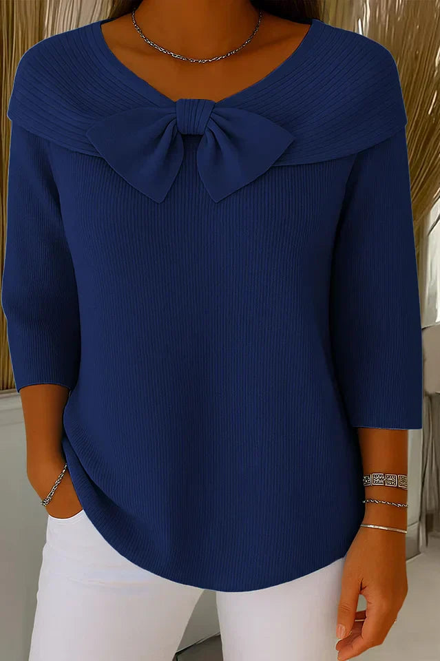 Texture shot of the knit fabric from the elegant knitted top, showing the soft feel and quality of the material.