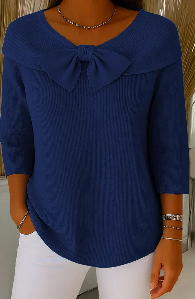 Texture shot of the knit fabric from the elegant knitted top, showing the soft feel and quality of the material.
