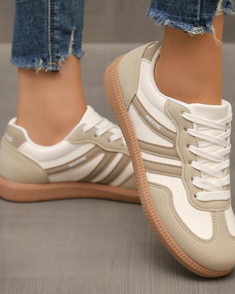 Detail of the breathable mesh upper on an off-white Elara orthopaedic cushioned trainer, indicating ventilation features.