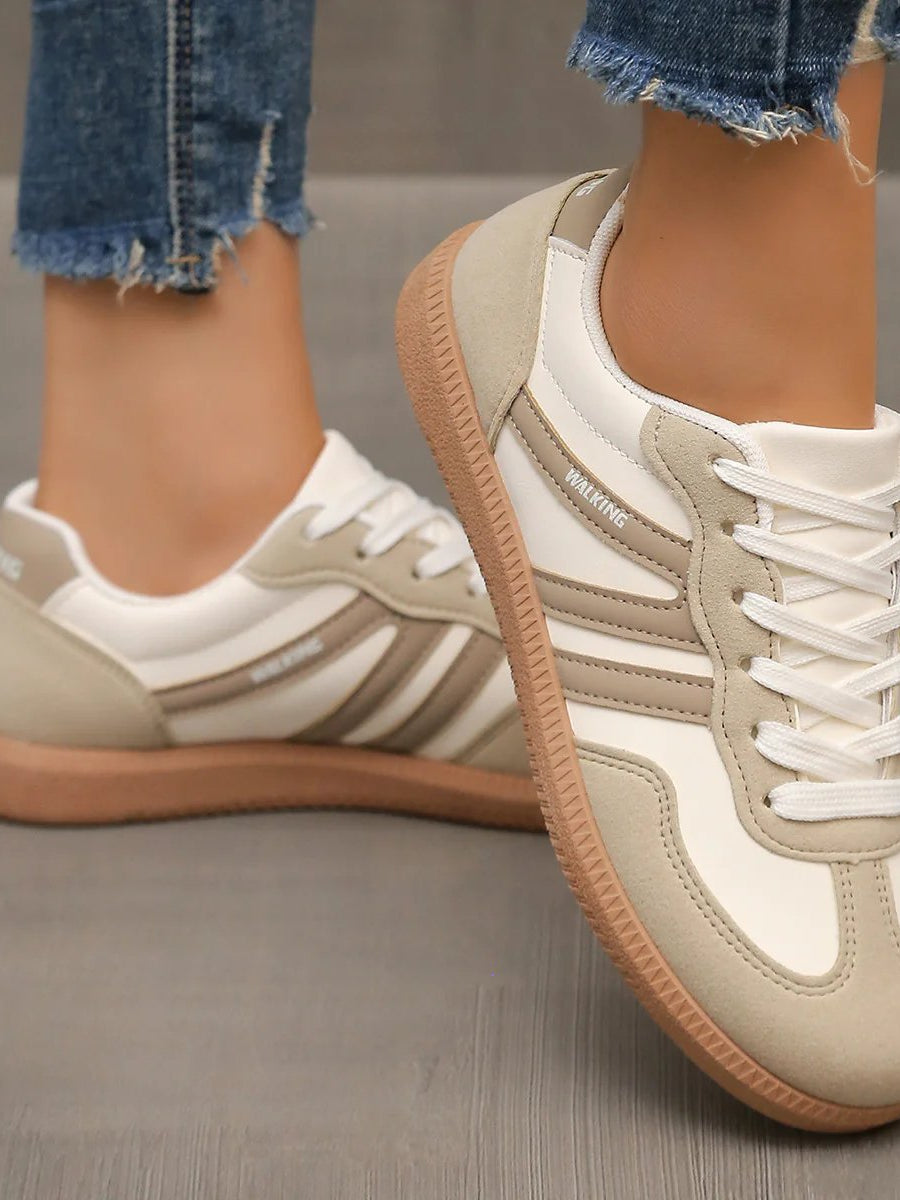 Detail of the breathable mesh upper on an off-white Elara orthopaedic cushioned trainer, indicating ventilation features.