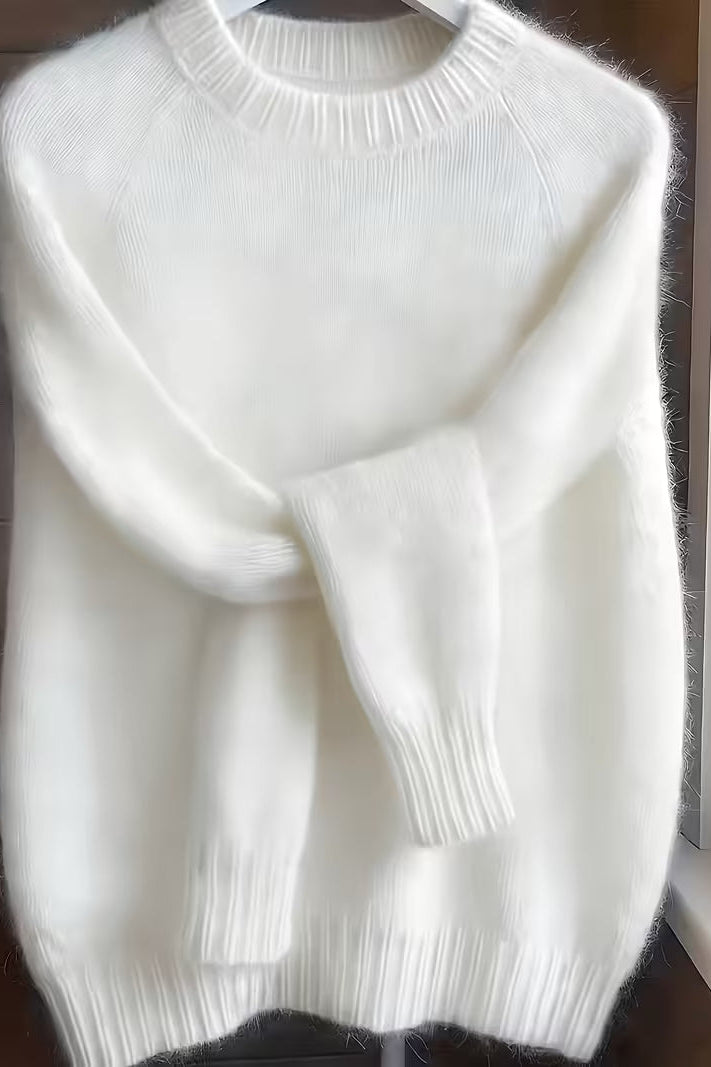 Close-up of the fabric texture on the green Elara cashmere-blend sweater, illustrating its premium blend and softness.