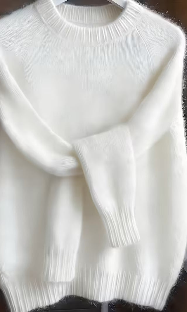 Close-up of the fabric texture on the green Elara cashmere-blend sweater, illustrating its premium blend and softness.