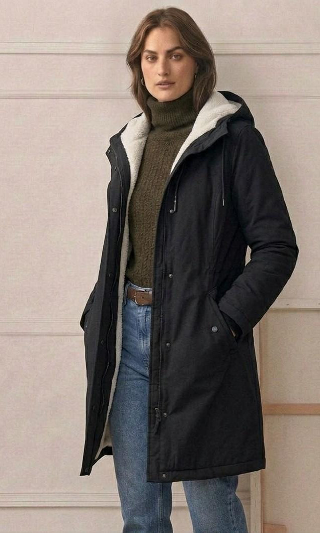 A model zipping up the Elara parka, illustrating the smooth operation of the wind-blocking closure.
