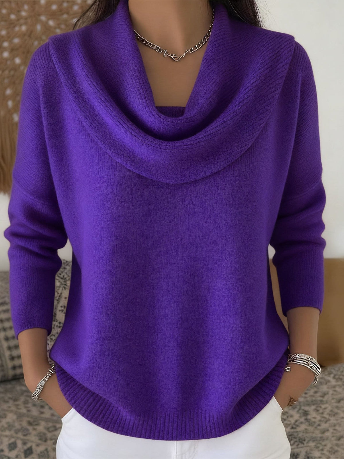 Lifestyle shot of Elina comfort fit pants in brown, paired with a sweater for a cozy, elegant look.