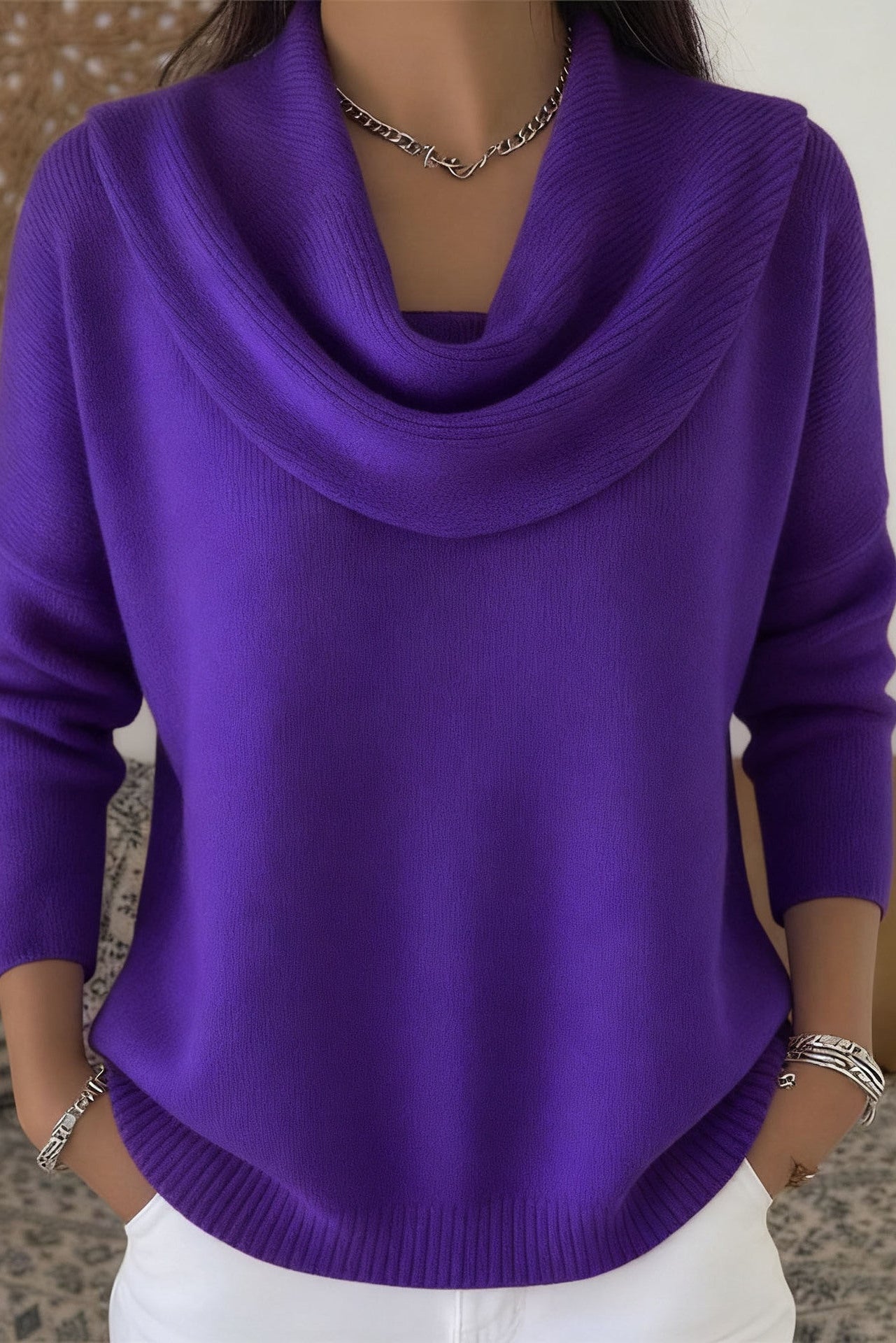 Lifestyle shot of Elina comfort fit pants in brown, paired with a sweater for a cozy, elegant look.