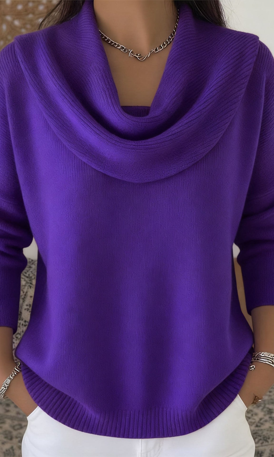 Lifestyle shot of Elina comfort fit pants in brown, paired with a sweater for a cozy, elegant look.