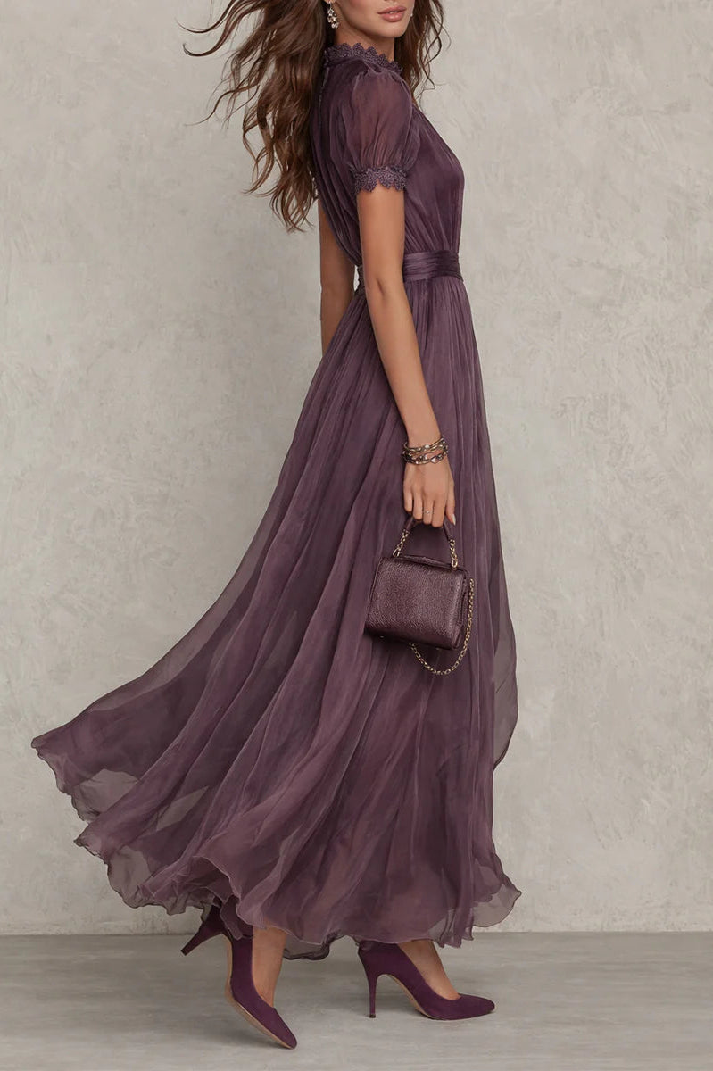 Close-up detail of the delicate lace trim on the sleeve and neckline of the purple chiffon maxi dress.