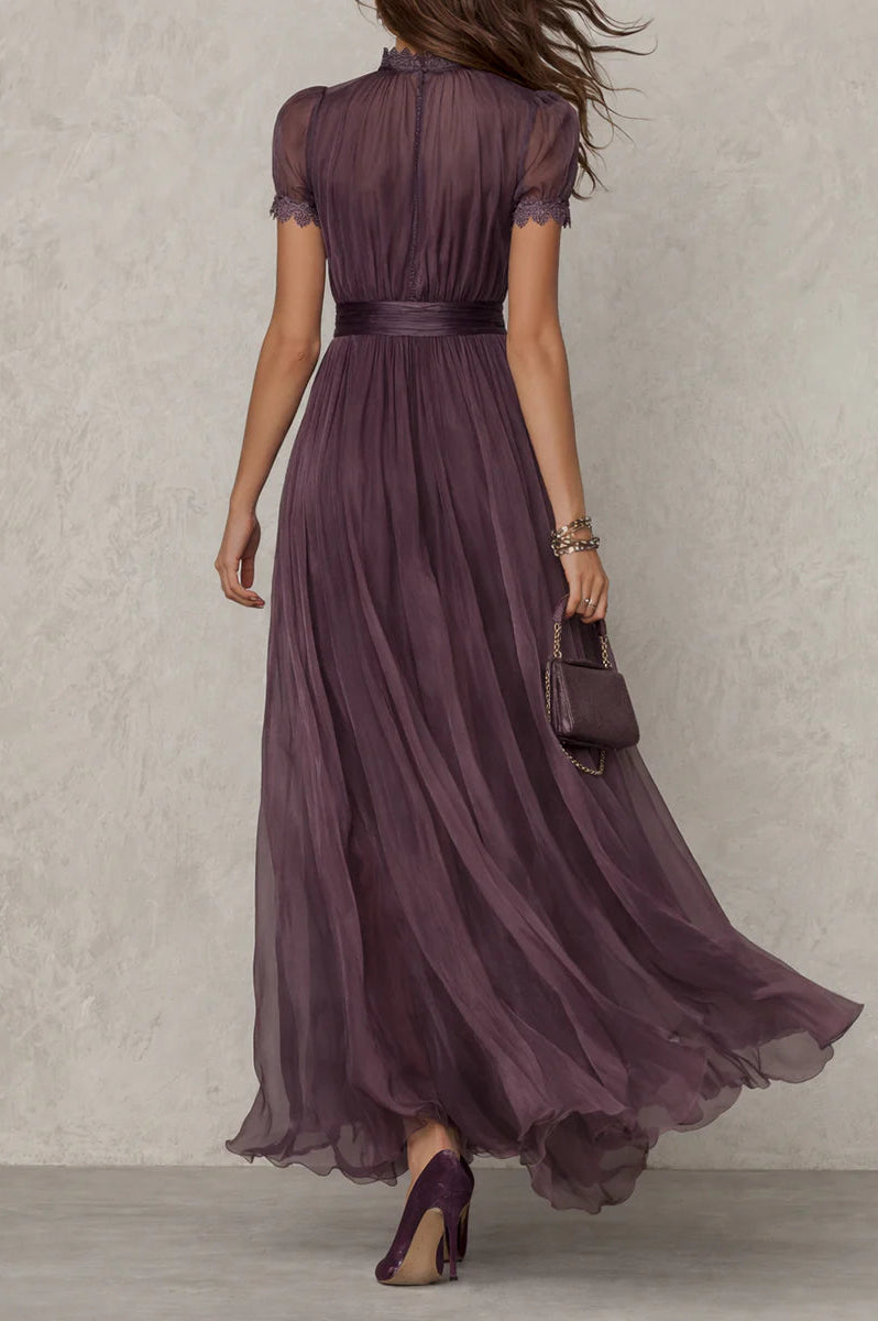 Side profile of a model wearing the Evadne purple chiffon lace maxi dress, highlighting its elegant drape and defined waist.