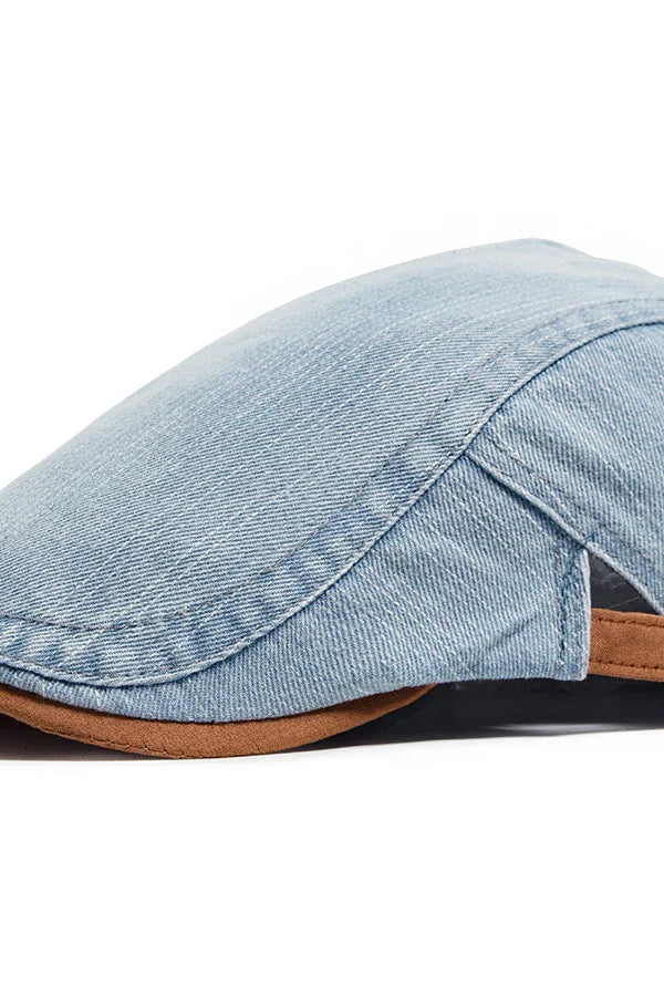 Side profile of the denim flat cap, highlighting the curved brim and tailored construction.