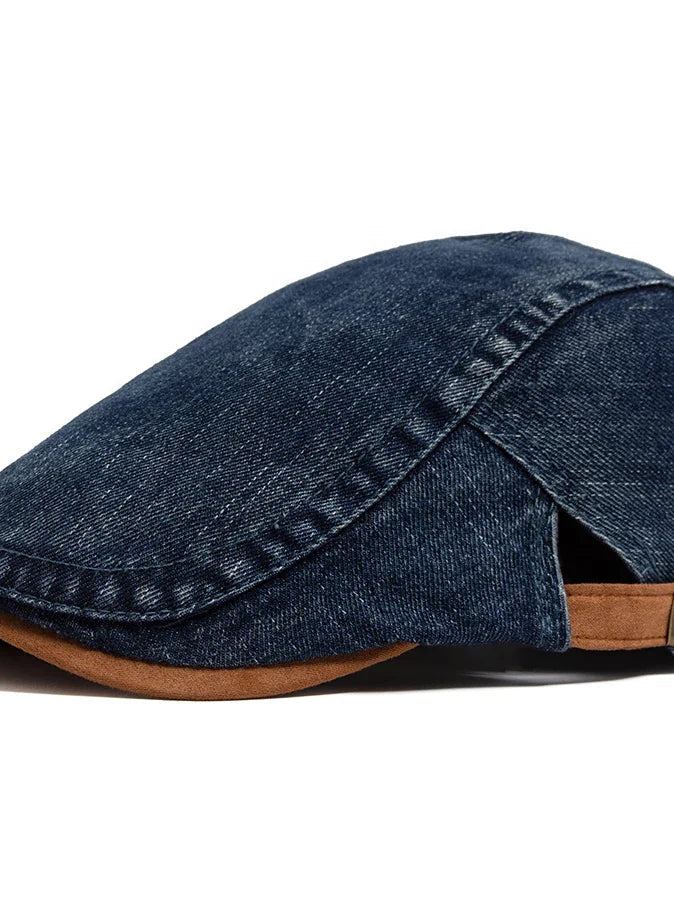 Close-up detail of the denim fabric on the flat cap, revealing its rich texture and quality stitching.