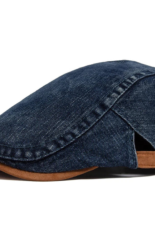 Close-up detail of the denim fabric on the flat cap, revealing its rich texture and quality stitching.