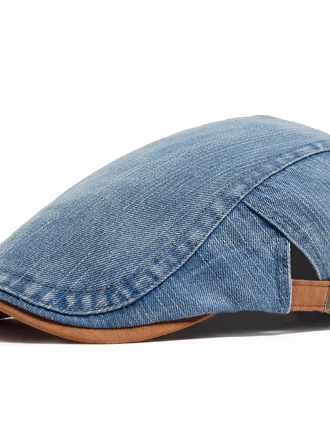 A man wearing the light blue denim flat cap, styled casually outdoors with a relaxed expression.