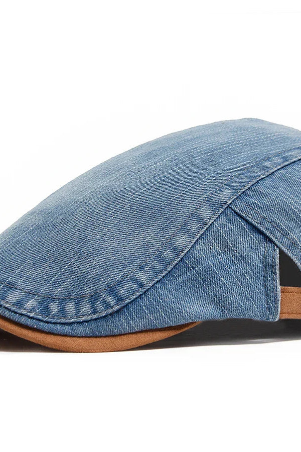 A man wearing the light blue denim flat cap, styled casually outdoors with a relaxed expression.
