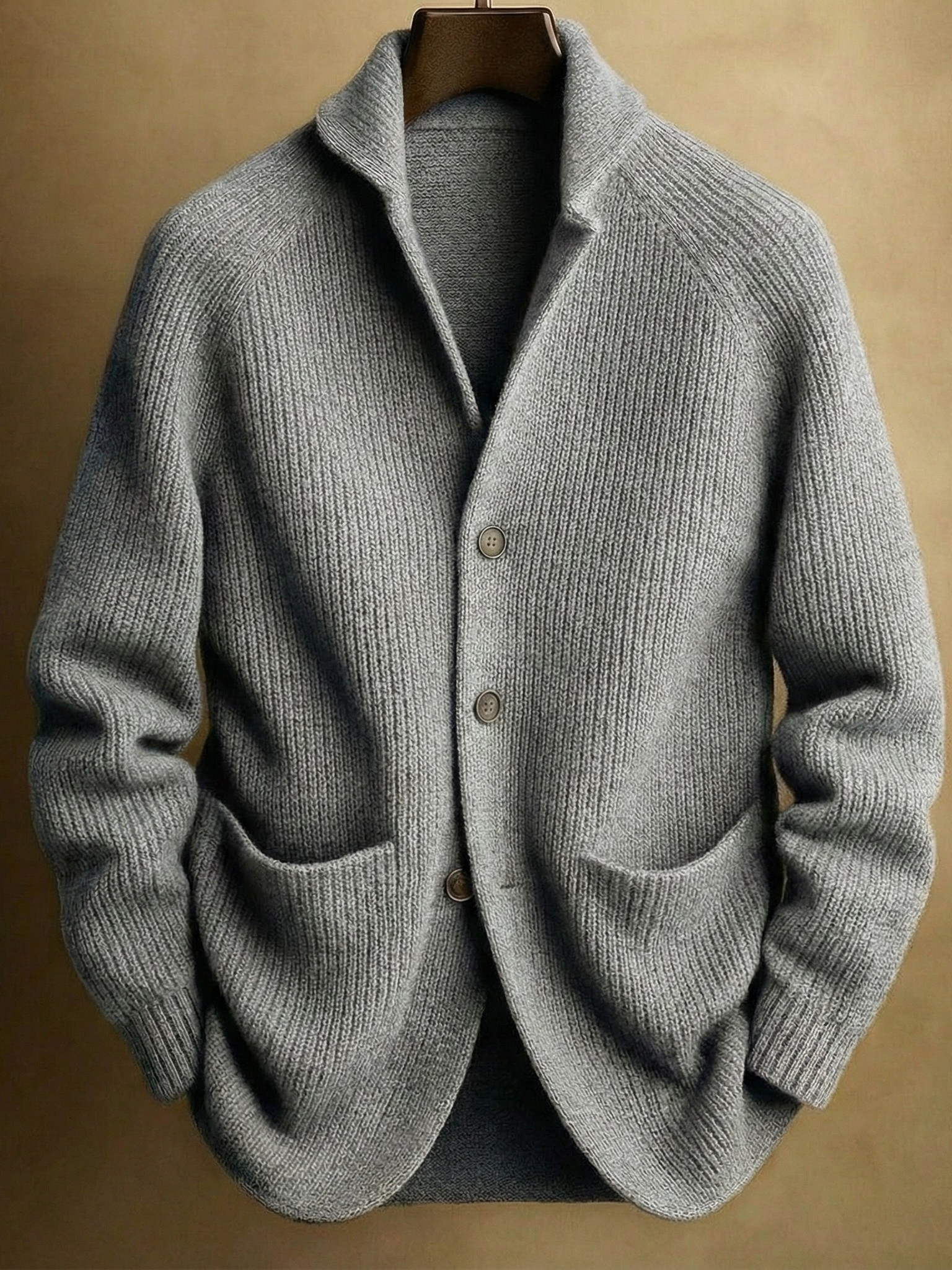 Hand in the front patch pocket of the Florian cardigan, demonstrating the practicality and size of the pockets.