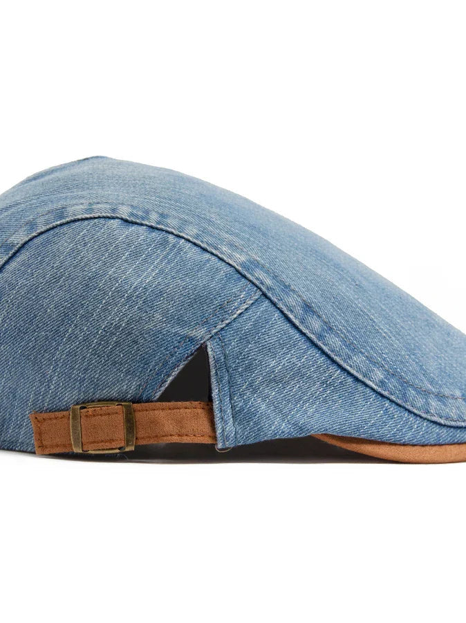 Overhead shot of the dark blue flat cap on a neutral background, emphasizing its symmetrical design.