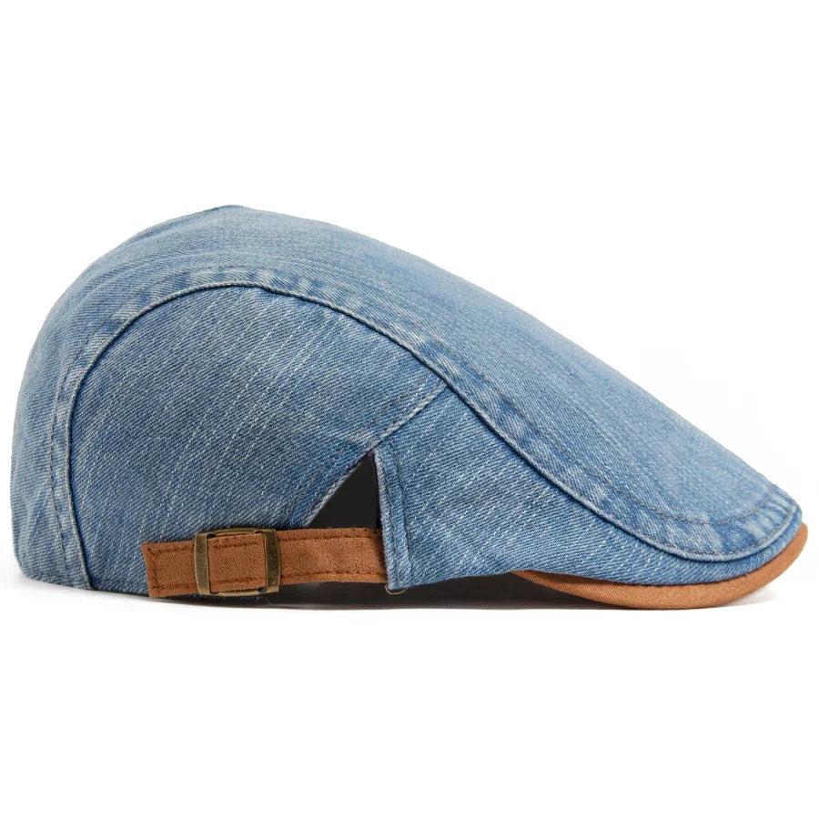 Overhead shot of the dark blue flat cap on a neutral background, emphasizing its symmetrical design.