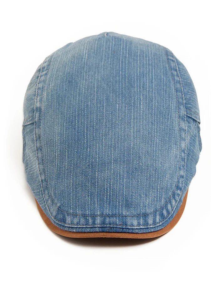 Back view of the denim flat cap, showing the subtle branding or seamless finish of the material.