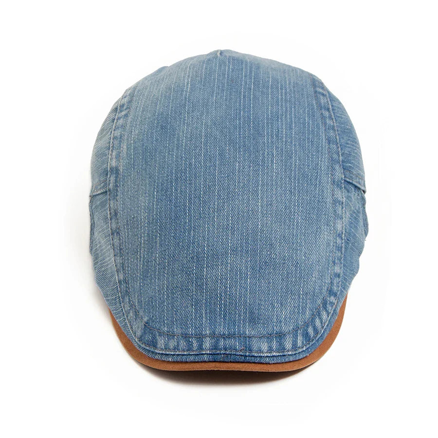 Back view of the denim flat cap, showing the subtle branding or seamless finish of the material.
