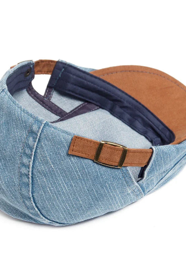 A stack of three denim flat caps in different colors (black, light blue, dark blue), showcasing the range.