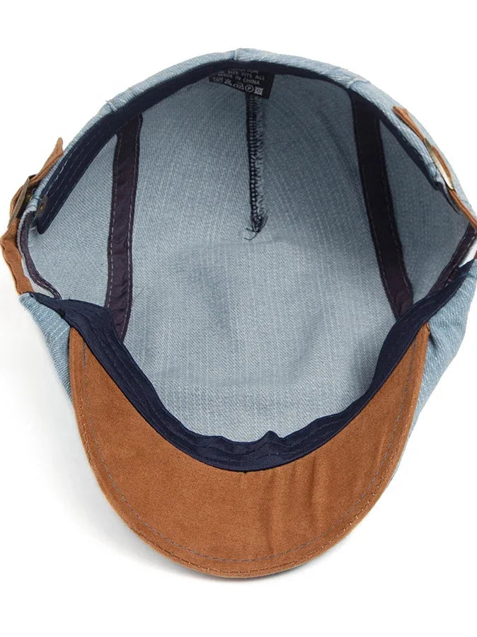Lifestyle image of the denim flat cap paired with a smart-casual outfit, adding a touch of sophistication.