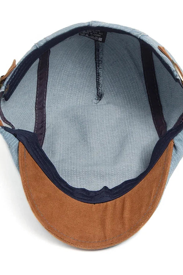 Lifestyle image of the denim flat cap paired with a smart-casual outfit, adding a touch of sophistication.