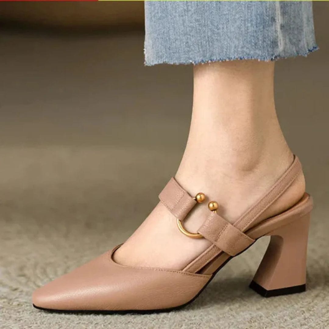 Studio shot of black leather slingback heels paired with dark wash denim jeans for a chic casual ensemble.