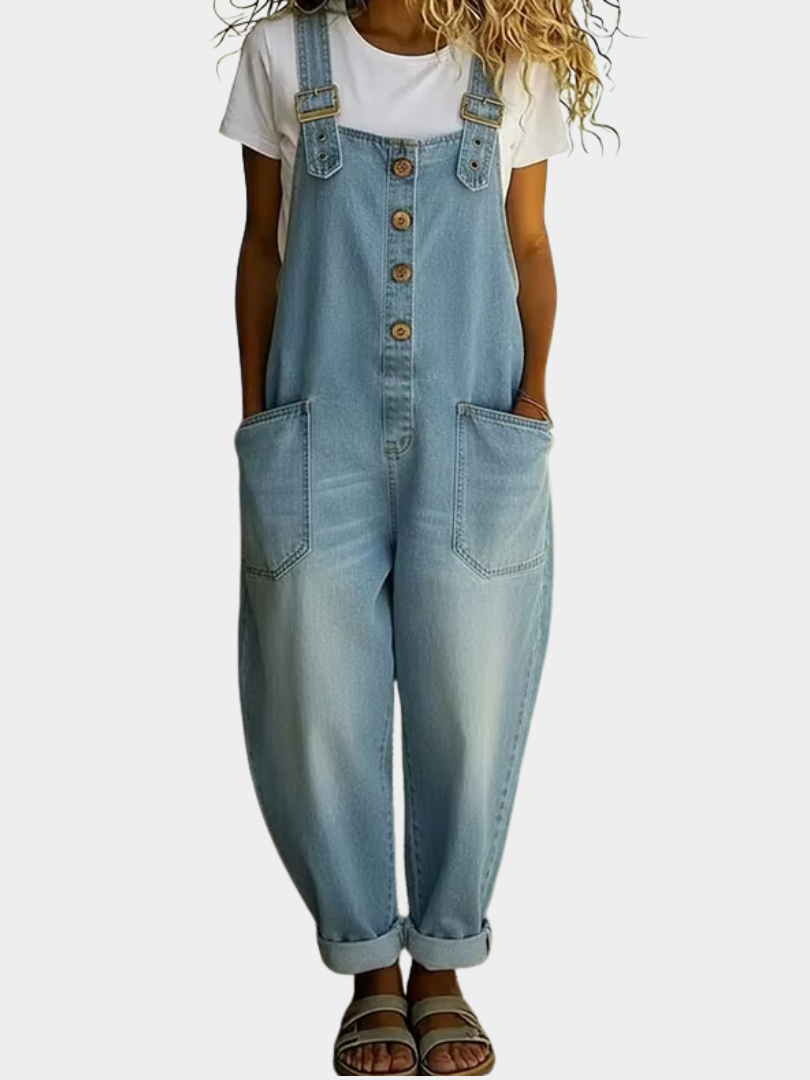 A woman models the light blue Hadley soft denim overalls from a front perspective, showcasing the relaxed wide-leg fit.