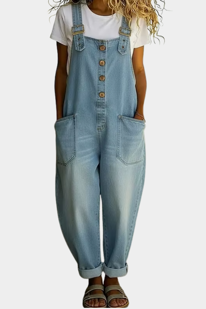 A woman models the light blue Hadley soft denim overalls from a front perspective, showcasing the relaxed wide-leg fit.
