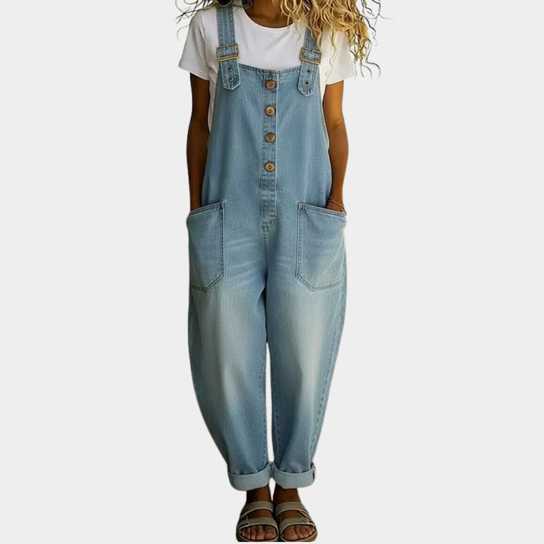 A woman models the light blue Hadley soft denim overalls from a front perspective, showcasing the relaxed wide-leg fit.