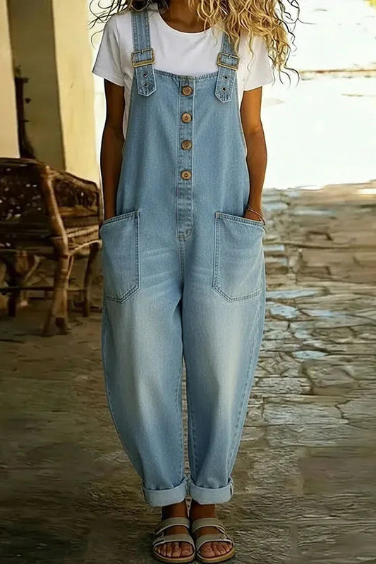 Close-up detail of the adjustable strap and bib pocket on the Hadley soft denim overalls, highlighting the fabric texture.