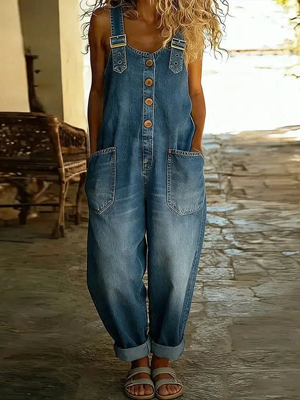 Side view of the Hadley soft denim overalls in blue, demonstrating the comfortable drape and silhouette while standing.