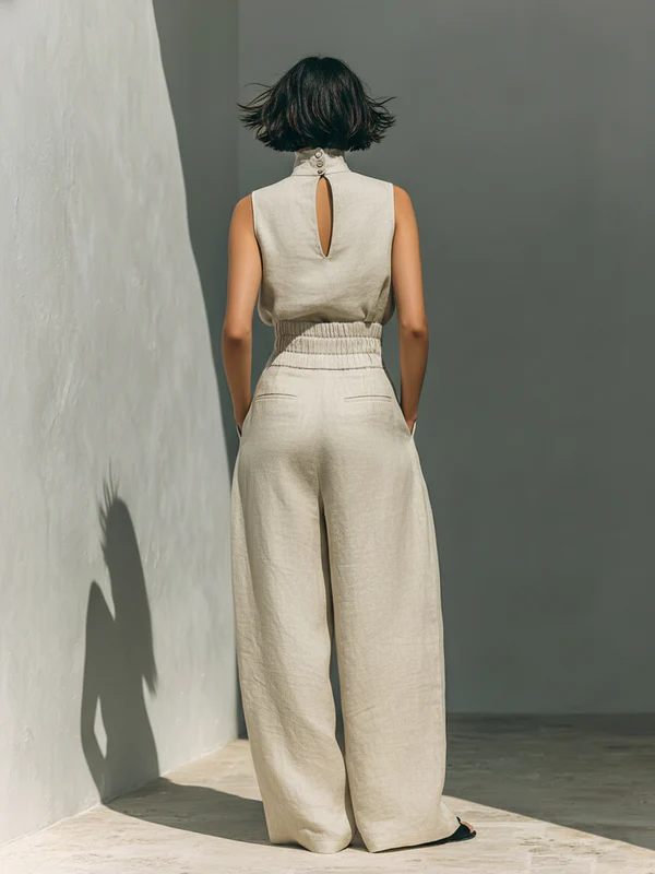 Lifestyle shot of a model wearing the light blue wide-leg trousers, demonstrating ease of movement.