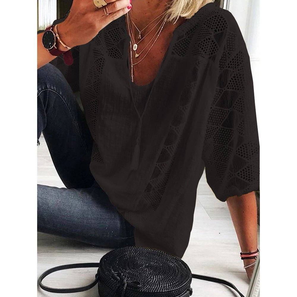 Close-up detail of the intricate crochet work and U-ring collar accents on the elegant blouse's neckline.