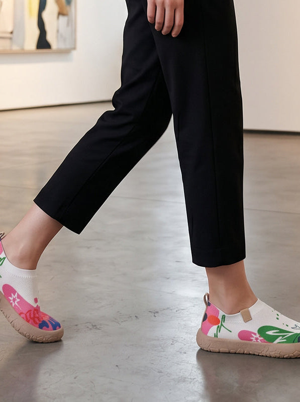 Close-up detail of the fuchsia artistic pattern on the breathable mesh upper of the slip-on shoes.