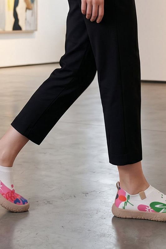 Close-up detail of the fuchsia artistic pattern on the breathable mesh upper of the slip-on shoes.