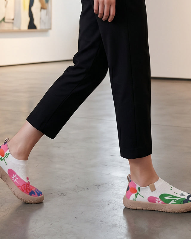 Close-up detail of the fuchsia artistic pattern on the breathable mesh upper of the slip-on shoes.