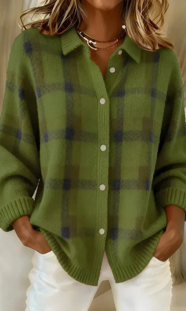 Close-up of the fabric texture and button closure on the orange Inez button-up cardigan.
