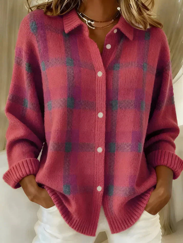 Inez button-up cardigan in green, folded neatly to show its soft material and simple design.
