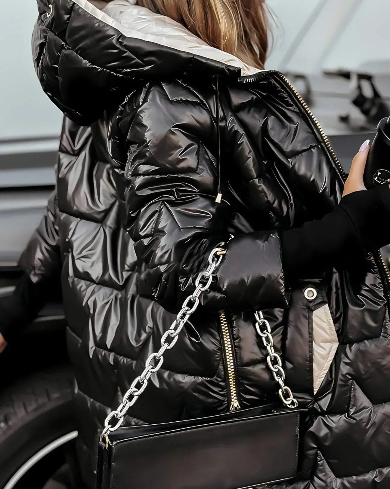 Frontal view of a brown Kiera hooded winter jacket with the hood up.