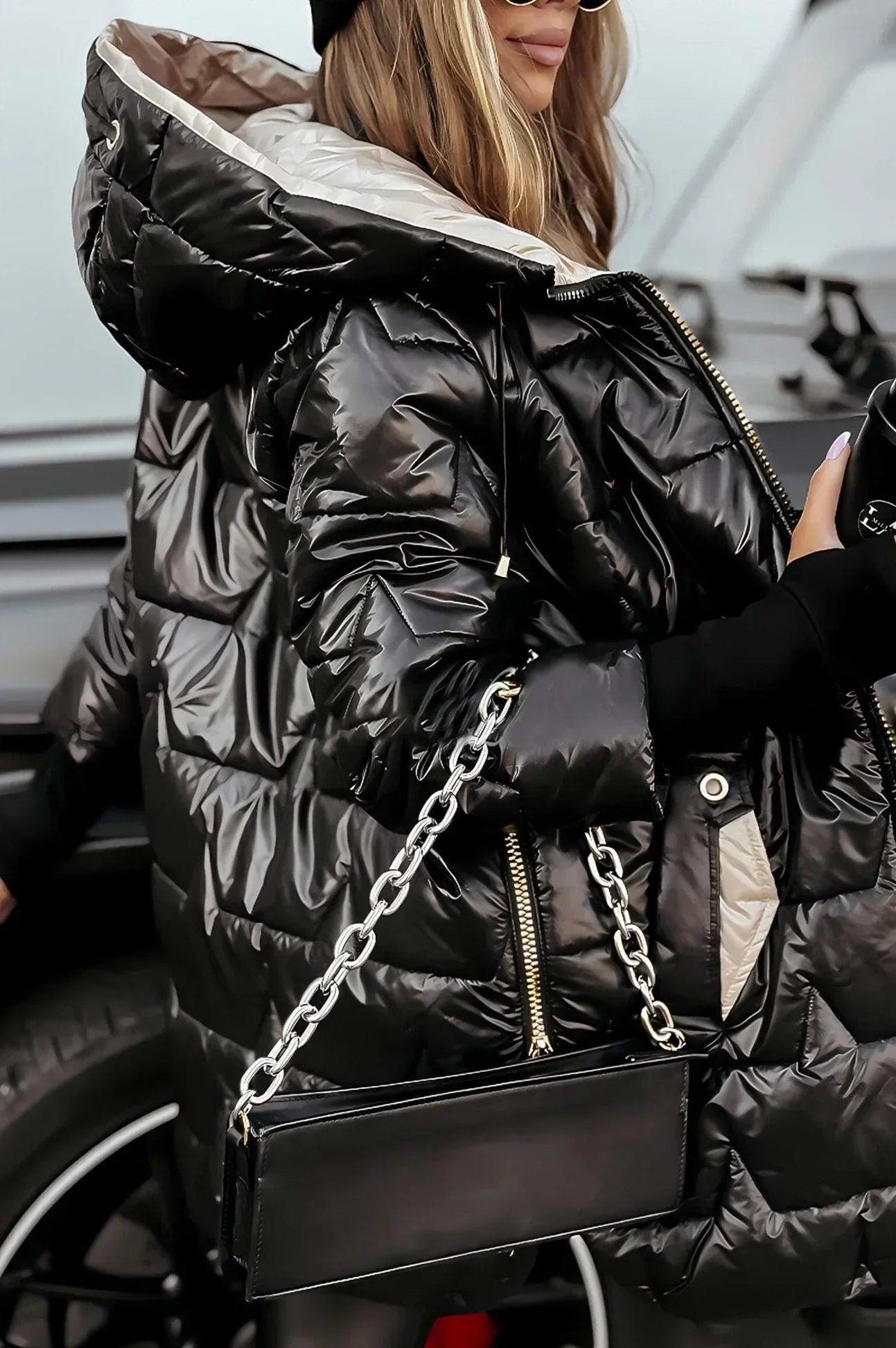 Frontal view of a brown Kiera hooded winter jacket with the hood up.