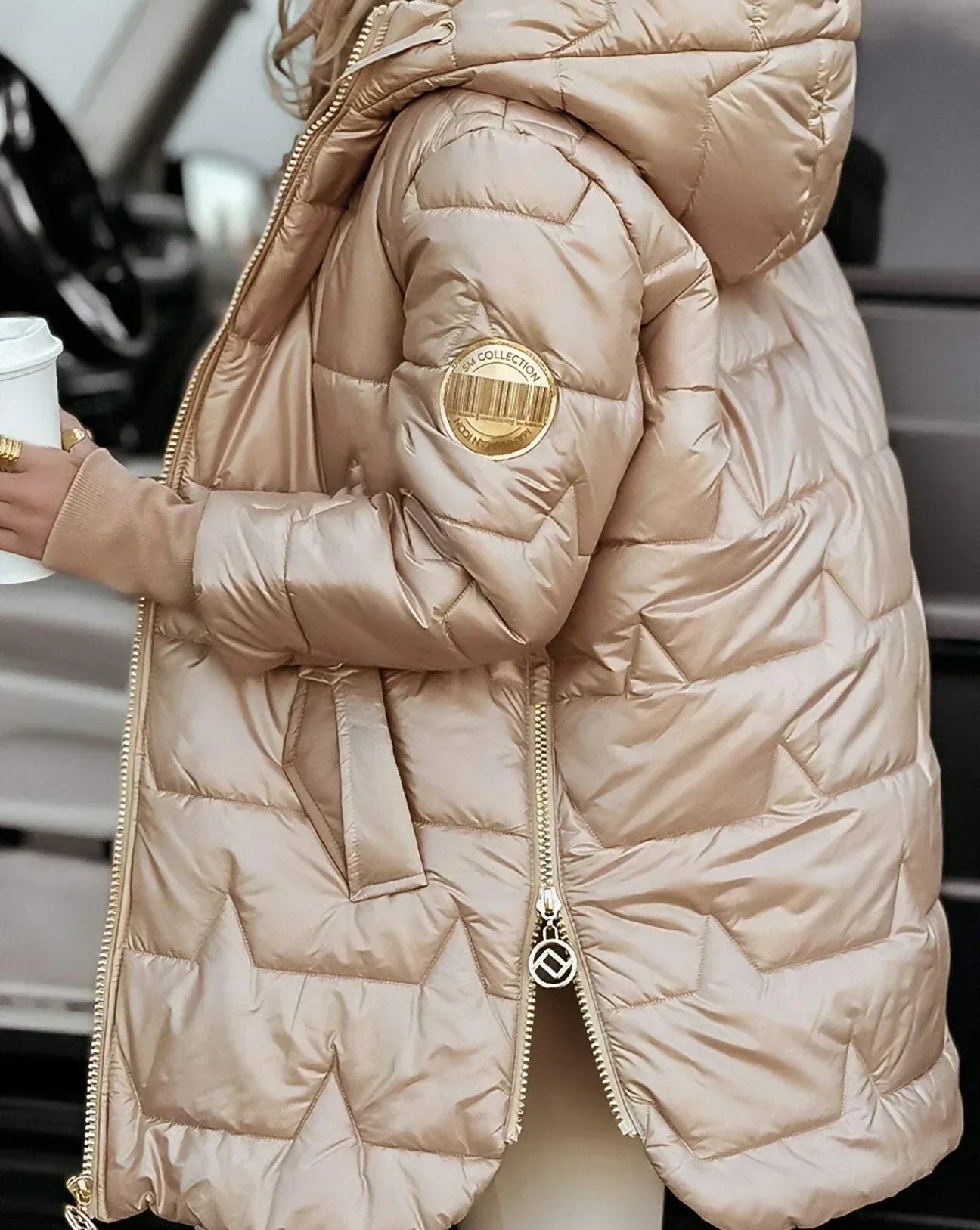 Model wearing a beige Kiera hooded winter jacket in an outdoor setting.