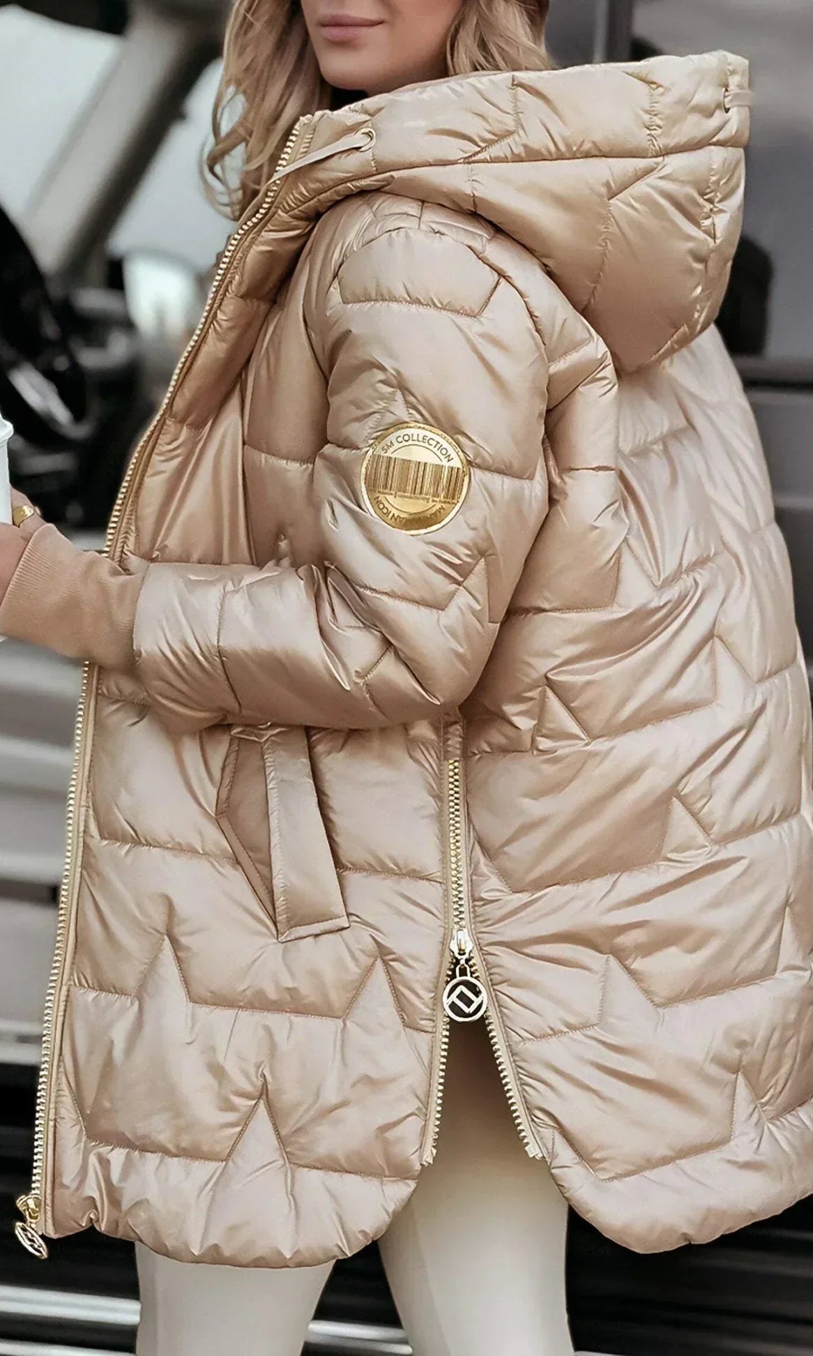 Model wearing a beige Kiera hooded winter jacket in an outdoor setting.