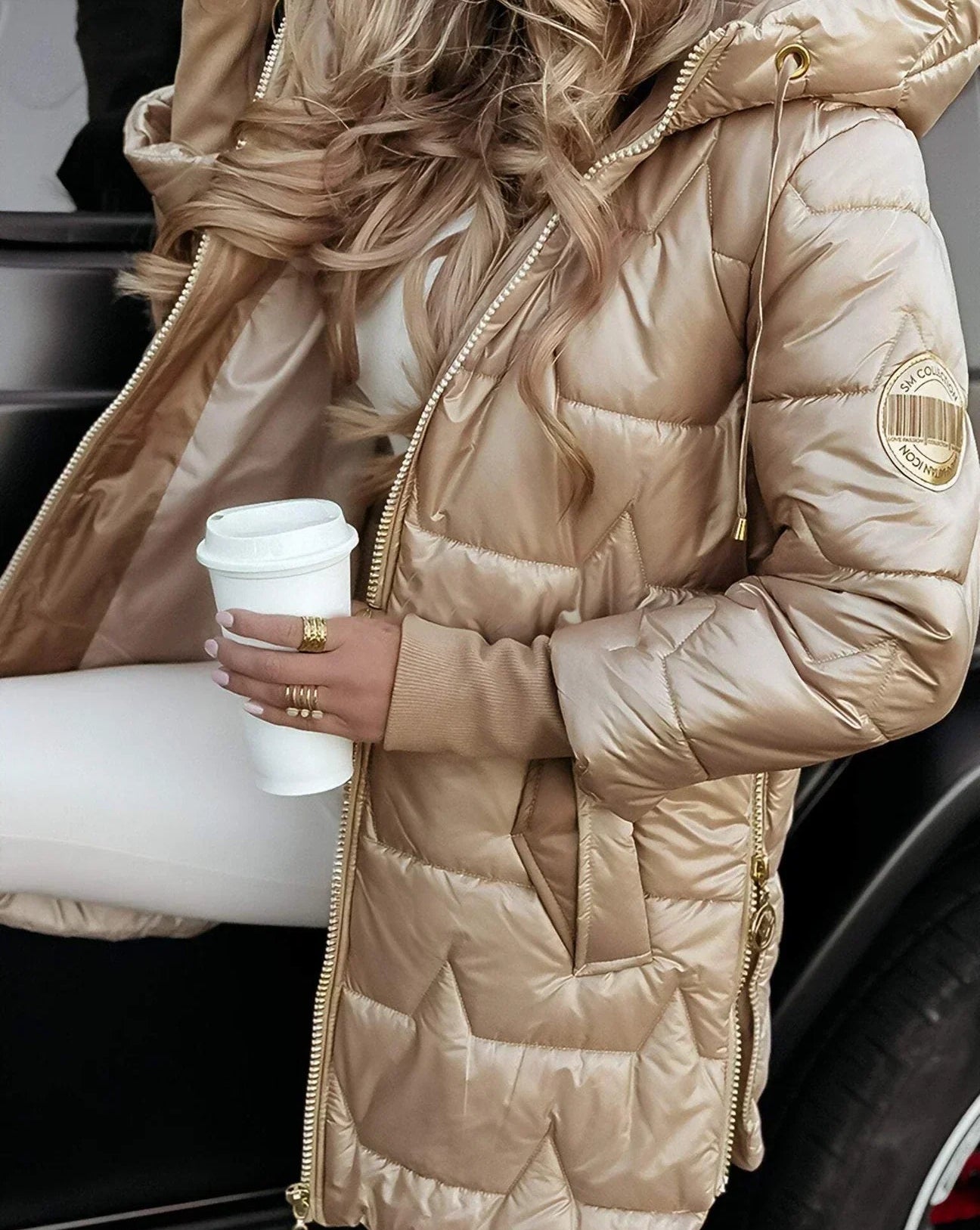 A pink Kiera hooded winter jacket styled with winter accessories.