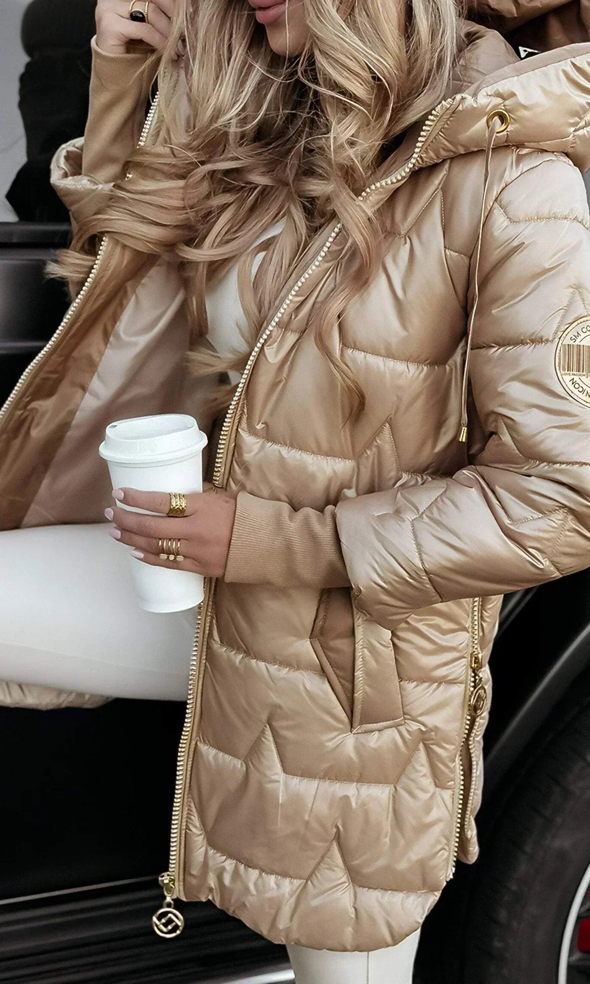 A pink Kiera hooded winter jacket styled with winter accessories.